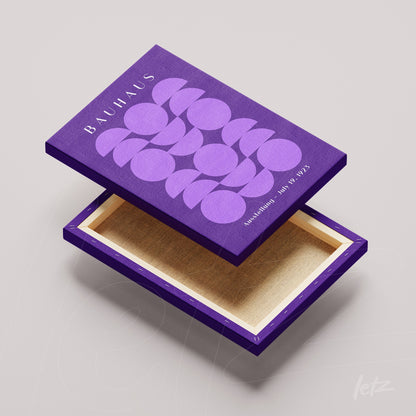 open wooden box with purple lid displaying geometric art inspired by Bauhaus movement