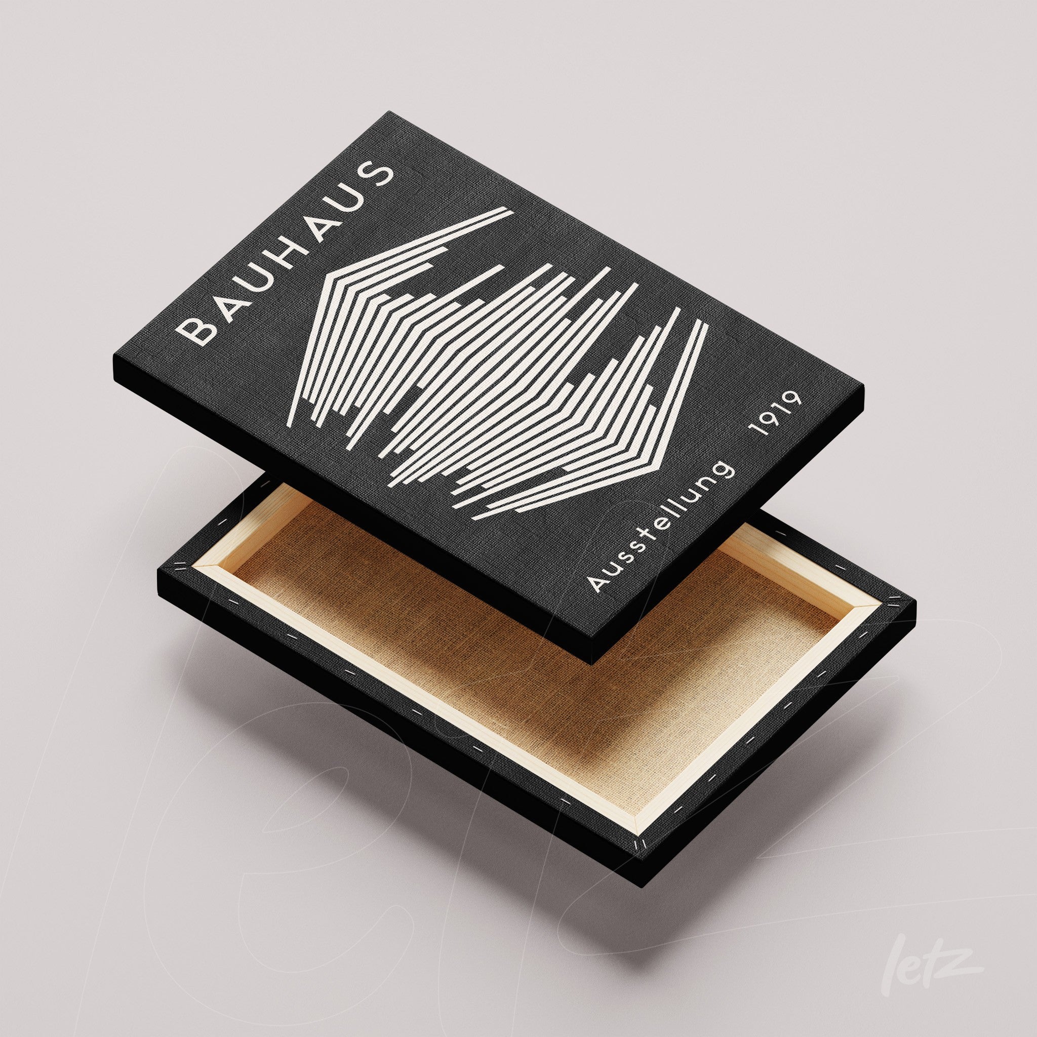 wooden box with lid removed featuring black and white graphic design from the Bauhaus movement with geometric lines and text