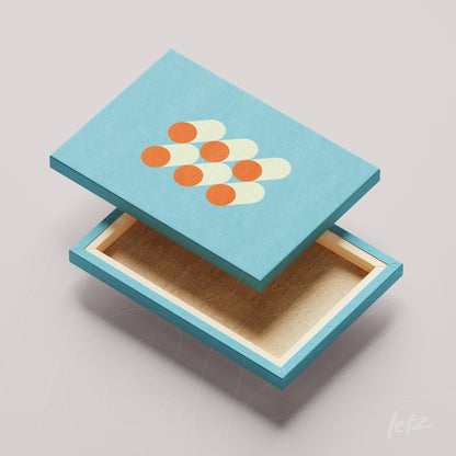 decorative box lid in blue with orange circles and yellow ovals on light gray background