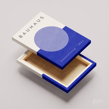 canvas print featuring modern bauhaus-inspired design with blue and white circles and lines, revealing the back and internal frame of the canvas
