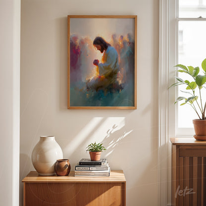 framed abstract art depicting a praying figure with soft colors and a light wooden frame