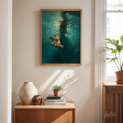 framed abstract art of a hand emerging from water with light wood frame