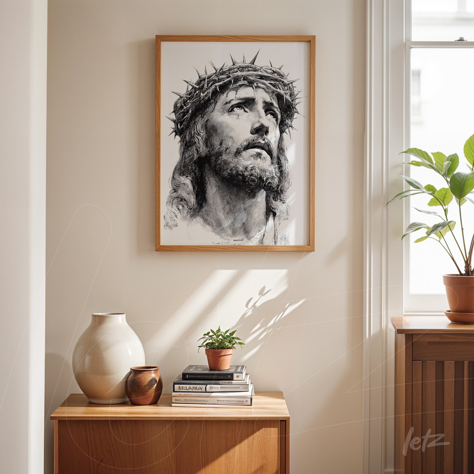 framed wall art featuring a black and white portrait of Christ with a crown of thorns displayed on a light wall