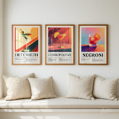set of decorative wall art featuring illustrations of drinks, including dirty martini, cosmopolitan, and negroni, in light wood frames
