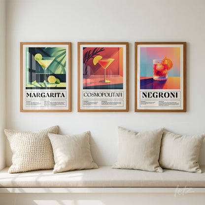 series of decorative cocktail art prints in light wood frames against a neutral background