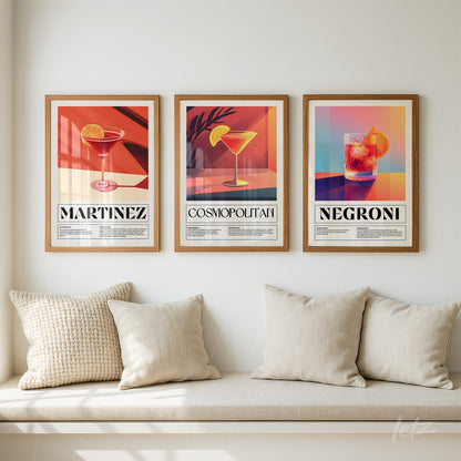 collection of framed illustrations of cocktails in light wood frame displayed on beige wall