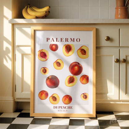 framed art print featuring peaches in light wood frame displayed in a sunlit kitchen
