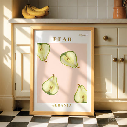 framed wall art featuring green pears on pink background with light wood frame and golden text