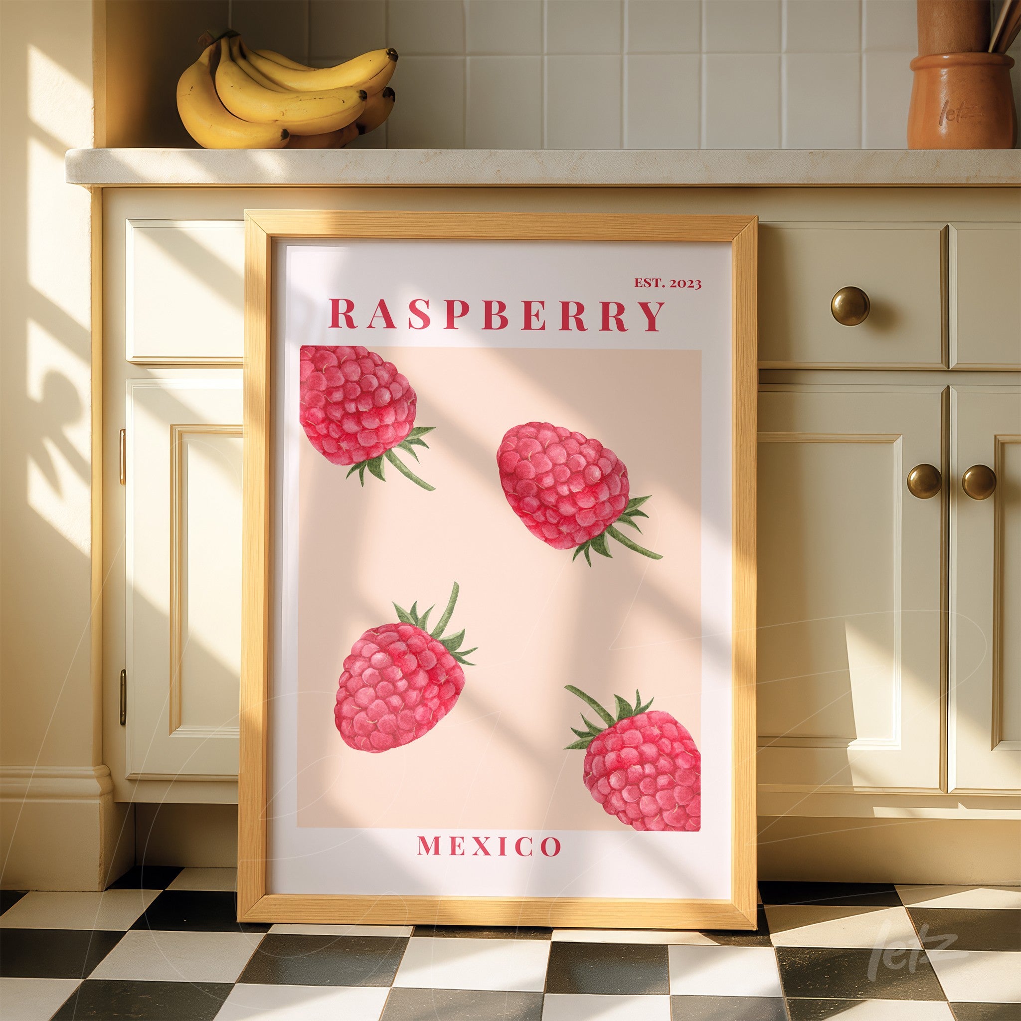 decorative wall art featuring raspberry illustrations on pink background with light wood frame