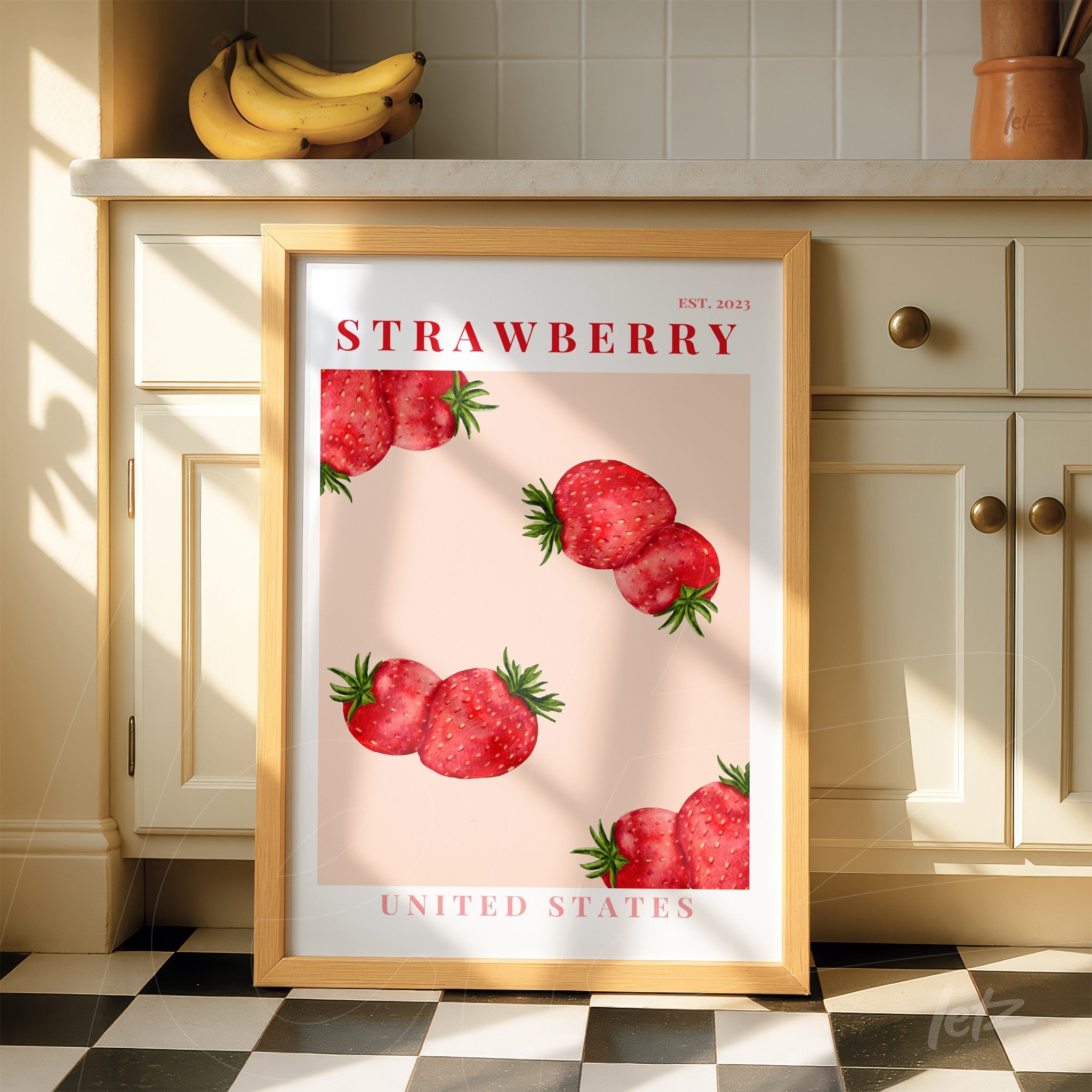 decorative artwork featuring strawberries on a pink background, framed in light wood with red text