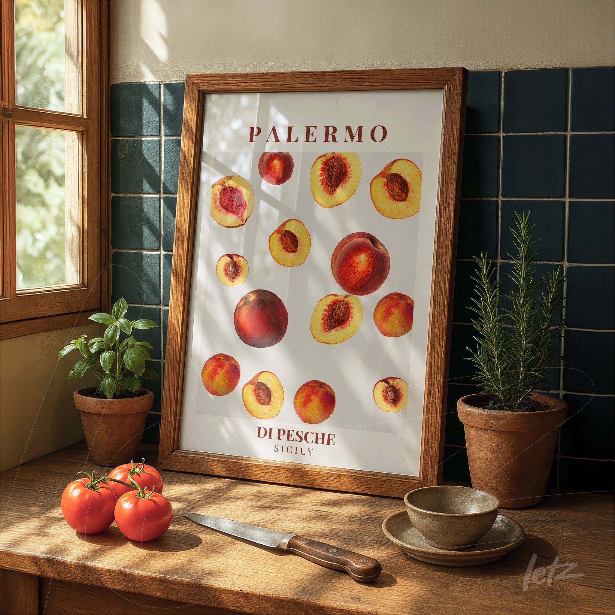 framed wall art featuring peaches in light wooden frame on wooden table with tomatoes and a knife