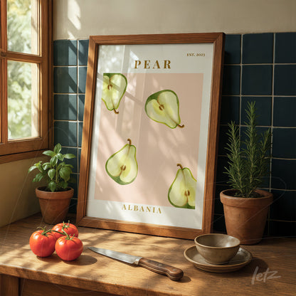 framed art featuring illustrations of pears on a pink background displayed on a wooden table with red tomatoes and herb pots