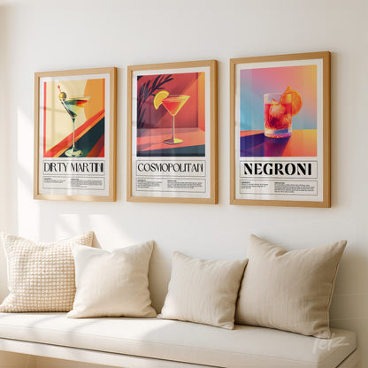 composition with three framed wall art of cocktails in gold frames displayed on a light wall