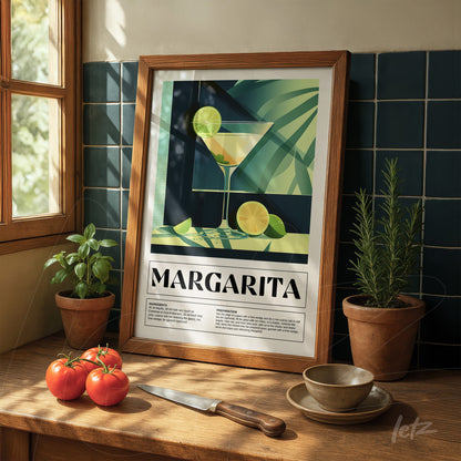 framed wall art of a margarita cocktail with light wood frame displayed on a table with tomatoes and potted plants