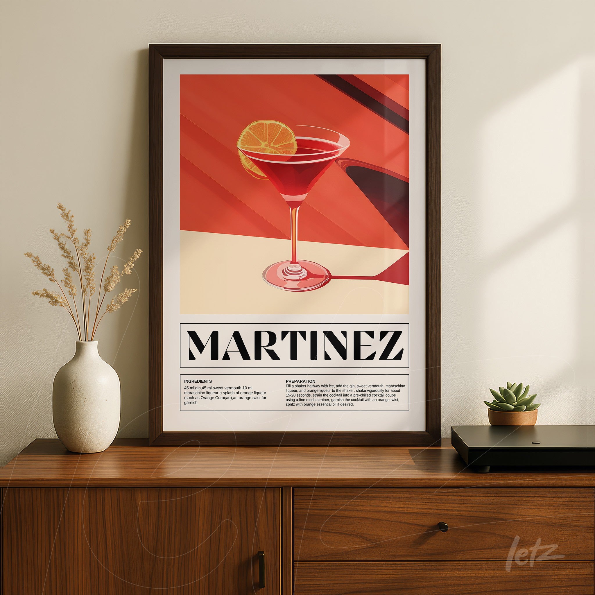 framed artwork of a stylized martinez cocktail in dark frame on a wooden surface