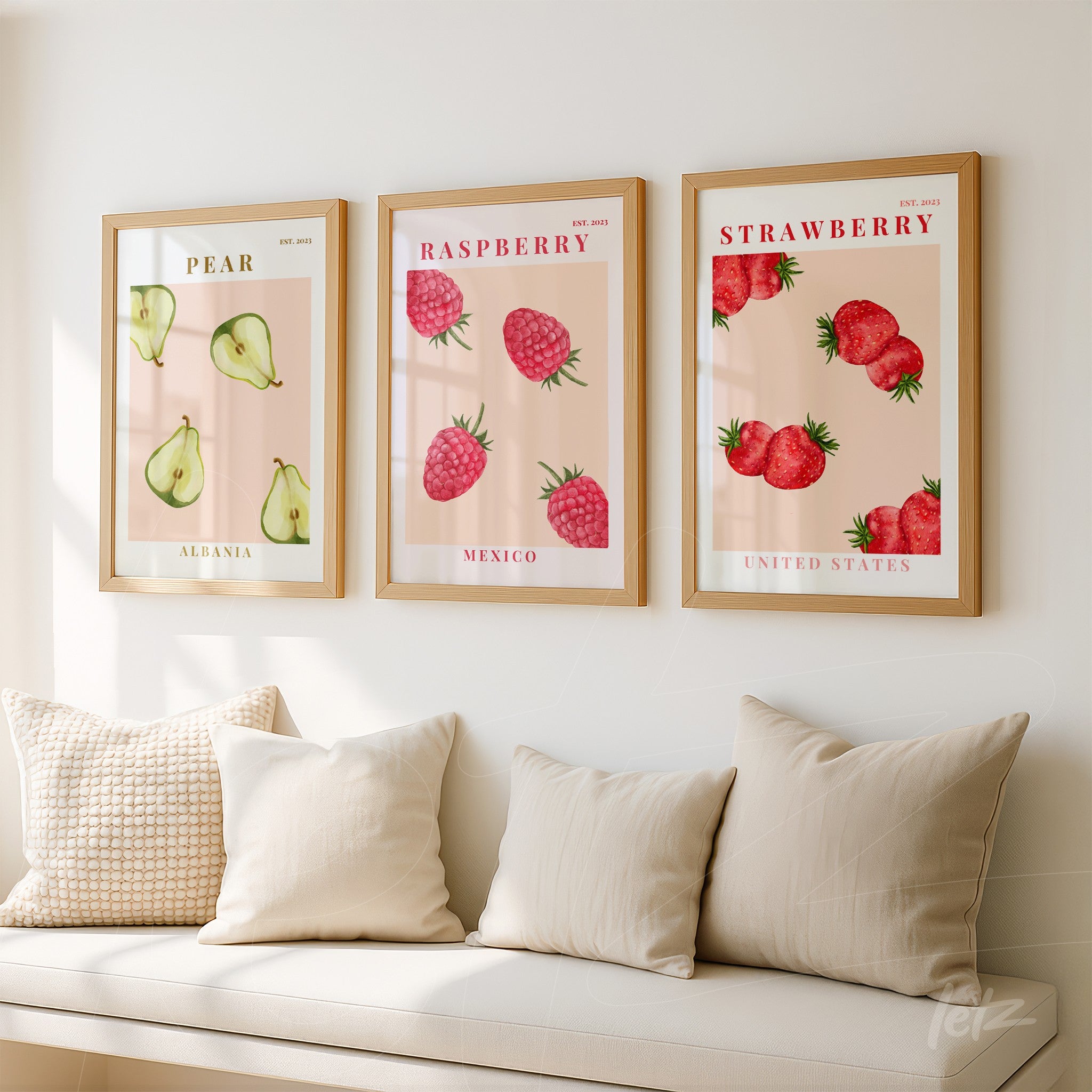 collection of framed wall art featuring stylized pear, raspberry, and strawberry in light frames on a light wall