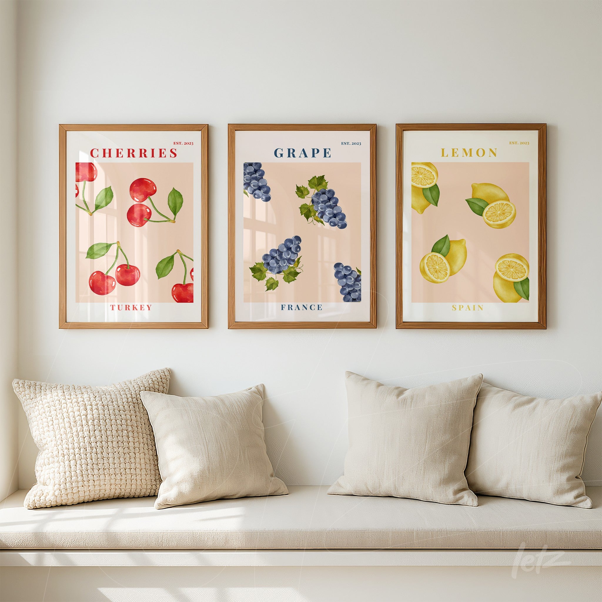collection of three framed artworks featuring illustrated fruits with cherry red, purple grapes, and yellow lemons against a soft neutral background