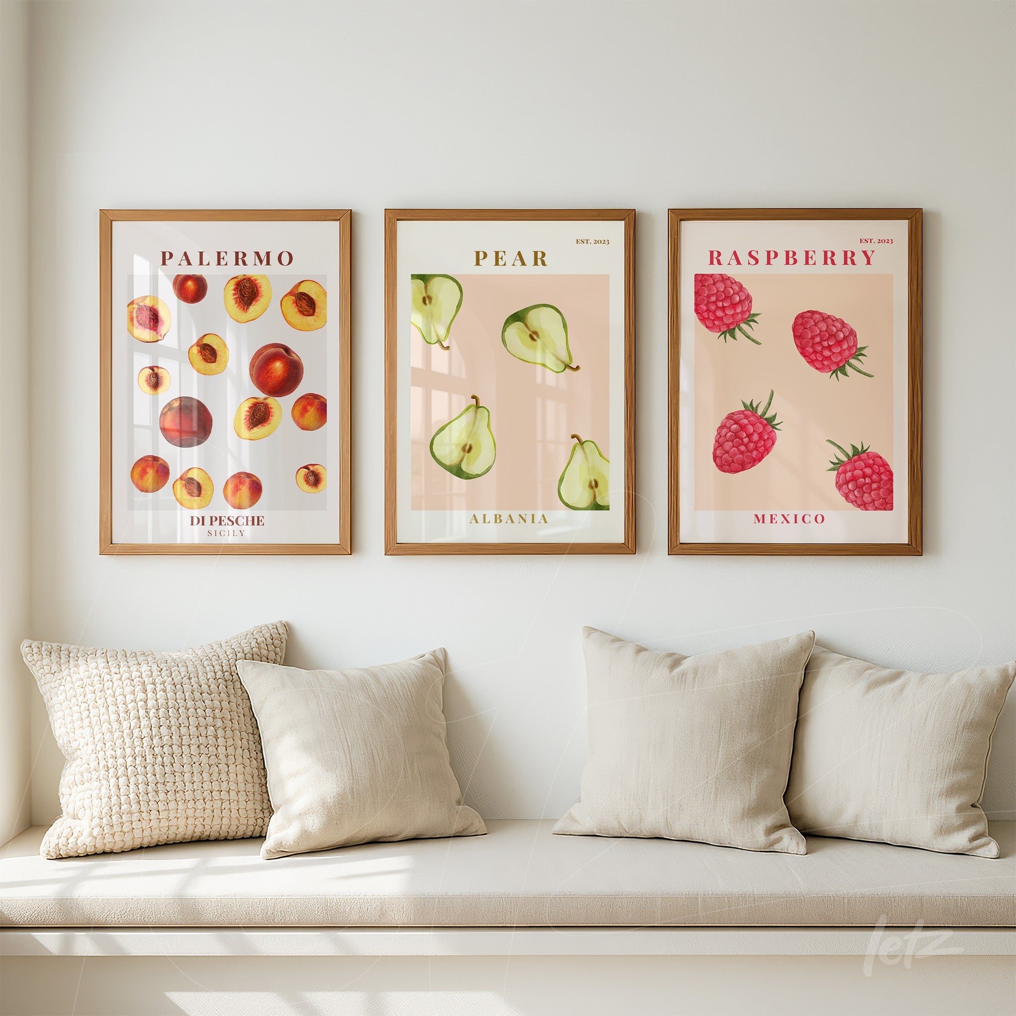 composition of wall art featuring fruits, including peaches, pears, and raspberries, in light wood frames against a white wall
