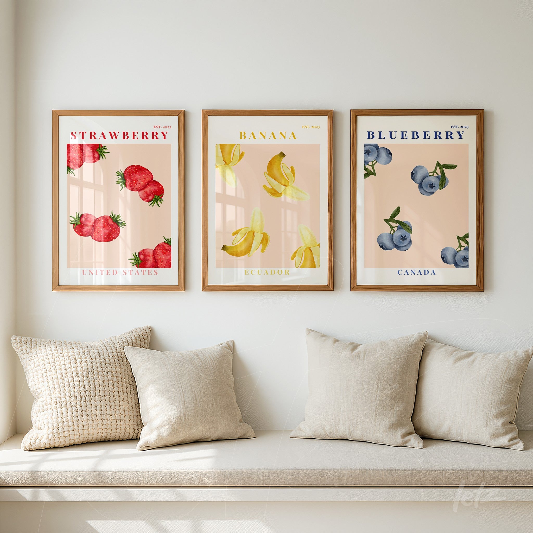 series of decorative wall art featuring fruits with light wood frame showcasing strawberries, bananas, and blueberries on pastel background