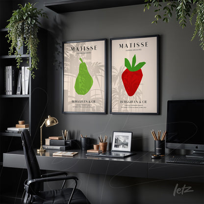 set of two framed wall art pieces featuring a green pear illustration and a red strawberry illustration against a neutral background