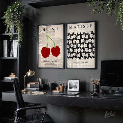 collection of framed wall art featuring red cherries and white flowers on a black background