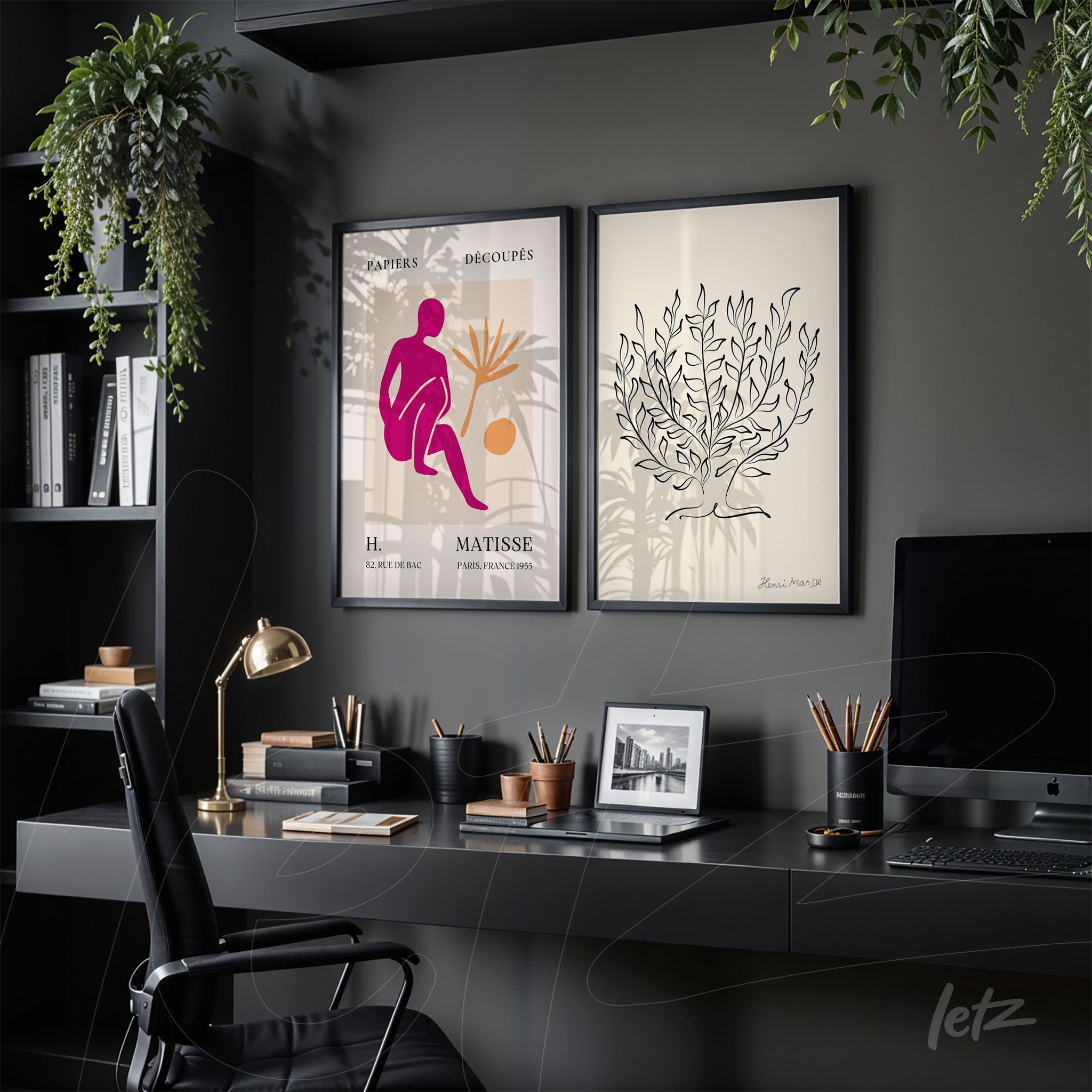composition of framed contemporary art featuring a stylized pink figure and a foliage illustration on light background, set against a dark gray wall in a modern office environment