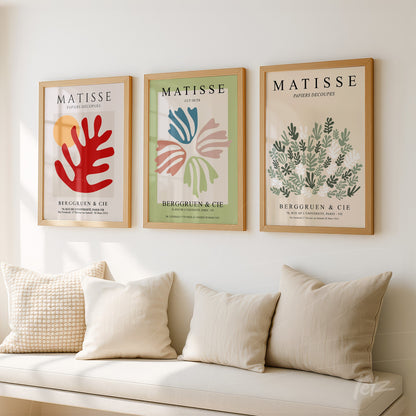 framed wall art set featuring three artistic prints with abstract shapes in vibrant colors against a neutral background