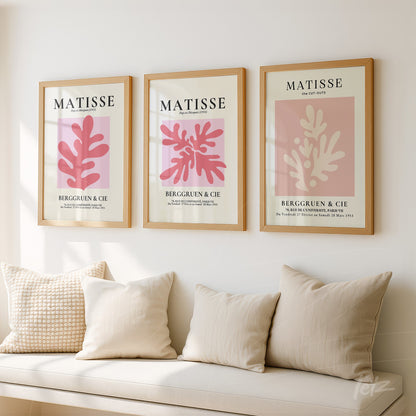 set of three framed modern art pieces featuring organic shapes in shades of pink on a neutral background