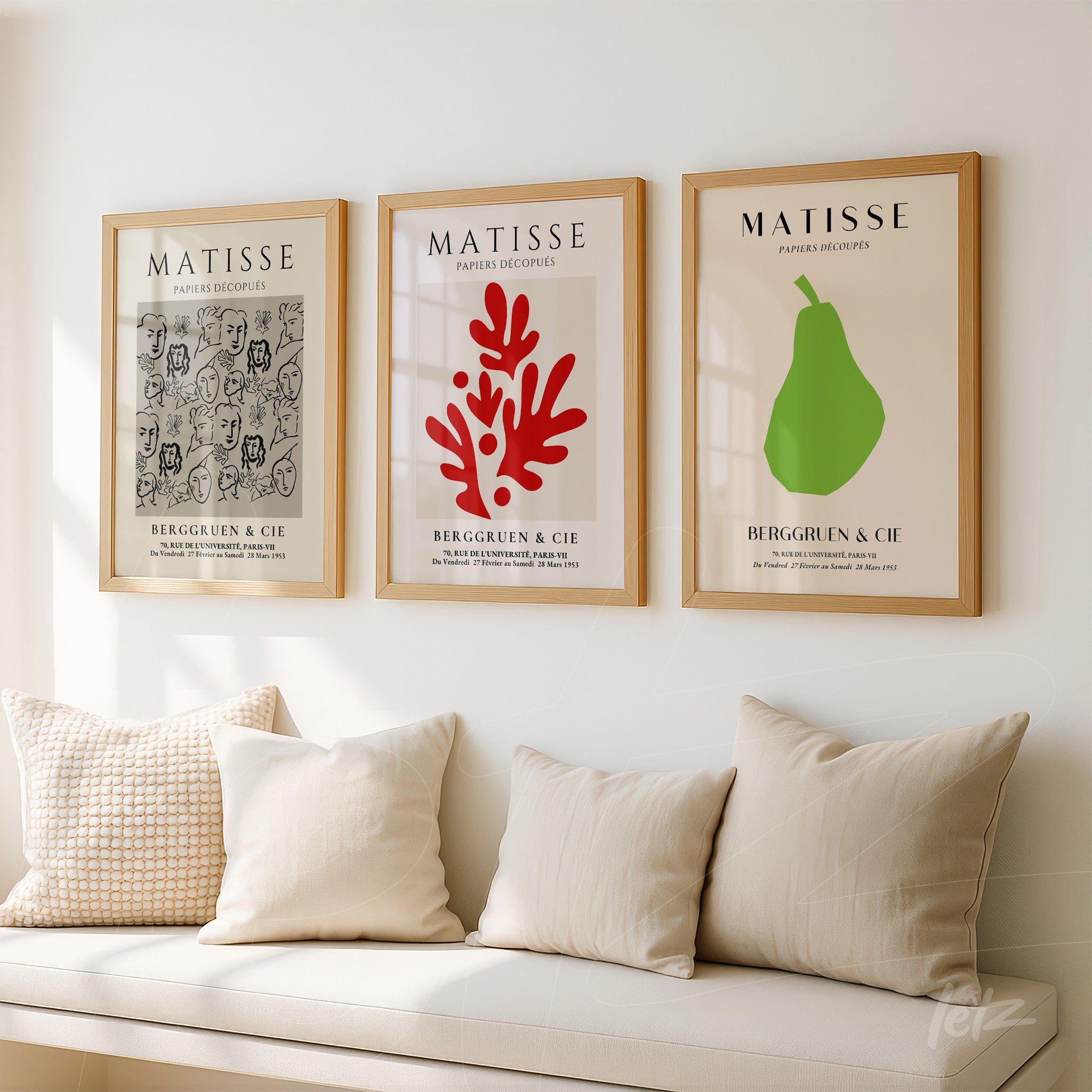 set of three framed wall art pieces by henri matisse featuring a modern illustration of faces, a red coral design, and a green pear against a white wall