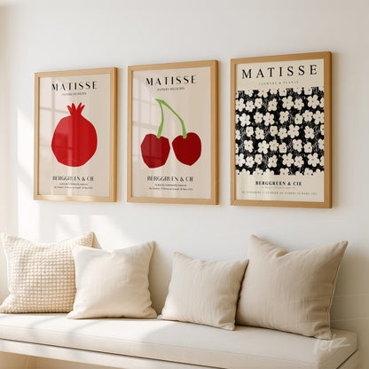 composition of three decorative framed artworks inspired by Matisse featuring elements like pomegranate, cherries, and white flowers on black background