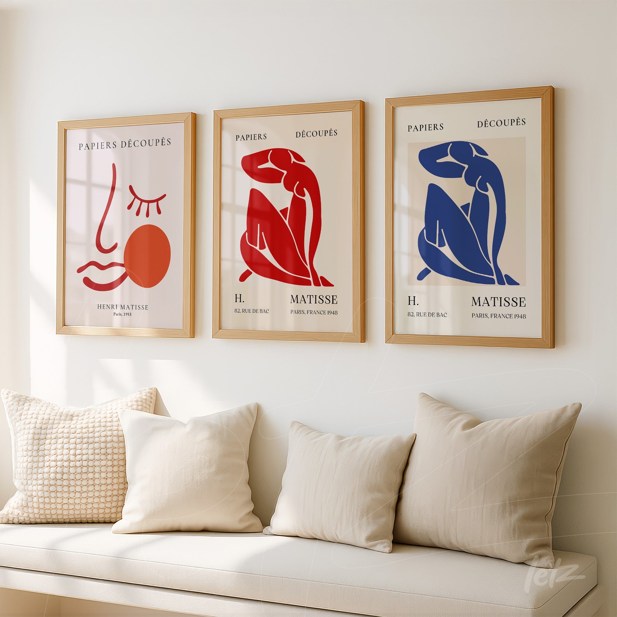 collection of three framed artworks in light wood featuring female figures in red and blue against a white background with simple typography