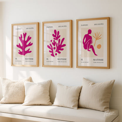 set of three decorative framed prints featuring colorful cut-outs displayed on a neutral wall