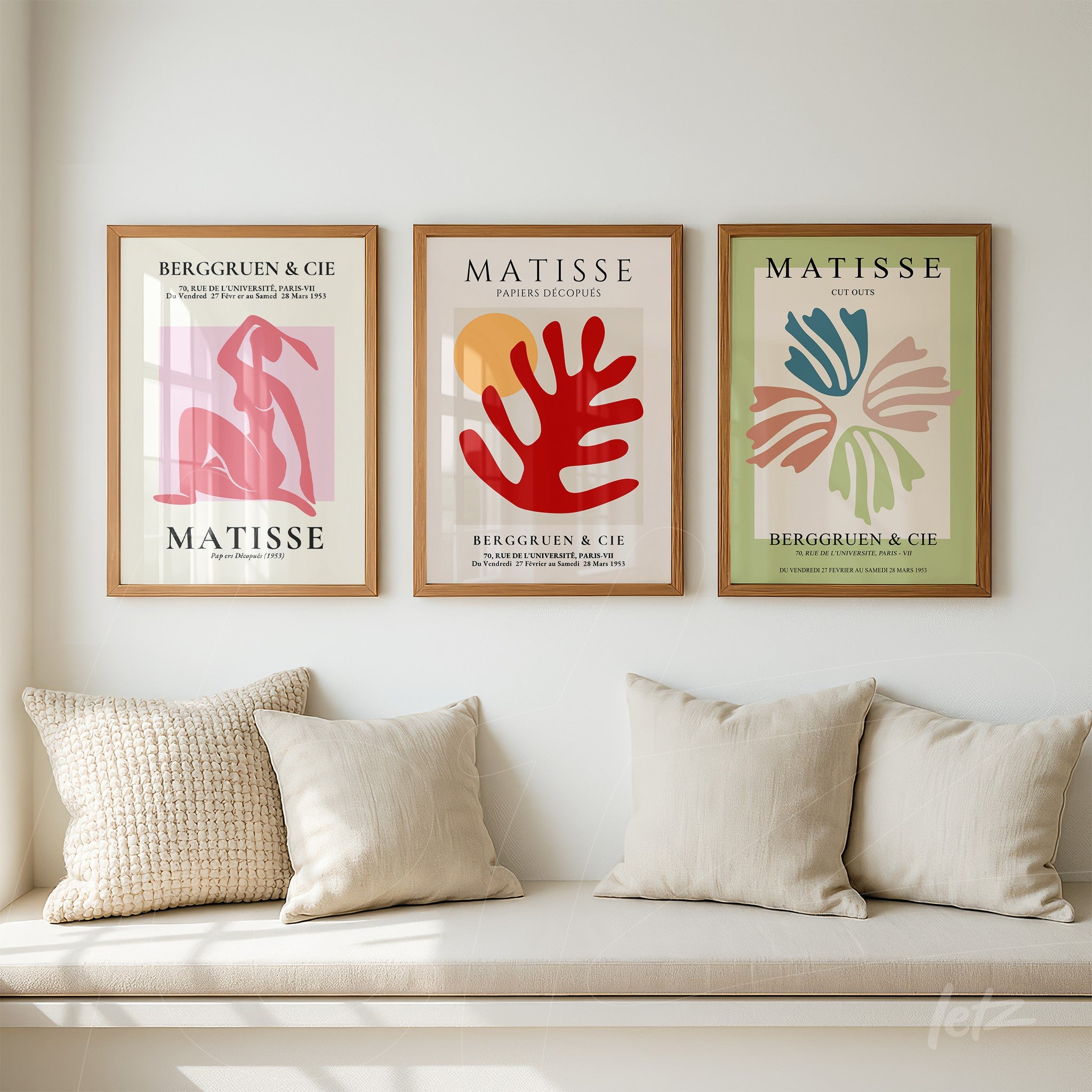 triptych of modern art prints by Matisse in light wood frames displayed on a white wall