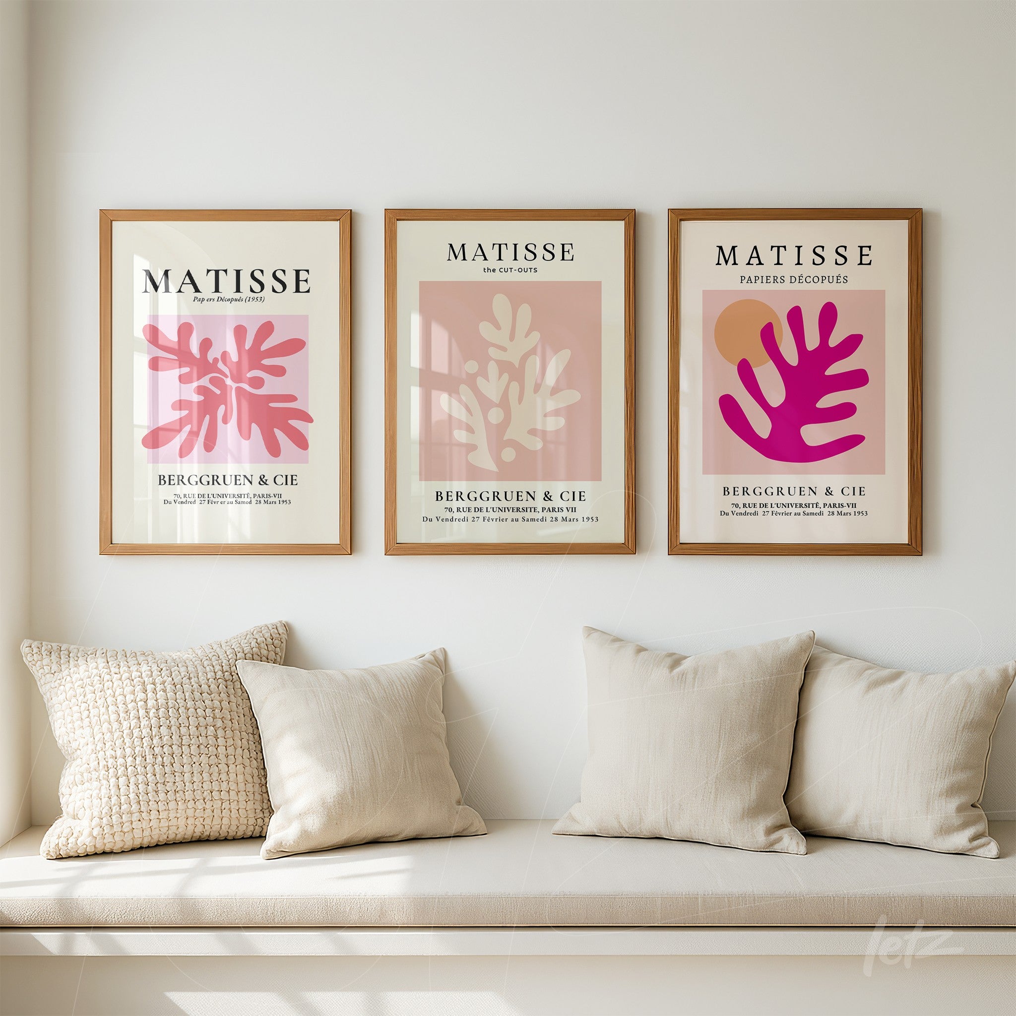 collection of framed art inspired by Matisse with light wood frames featuring botanical shapes in pink and brown tones on neutral backgrounds
