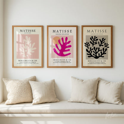 collection of three framed artworks inspired by Matisse featuring abstract shapes in shades of pink, purple, and black on a light background