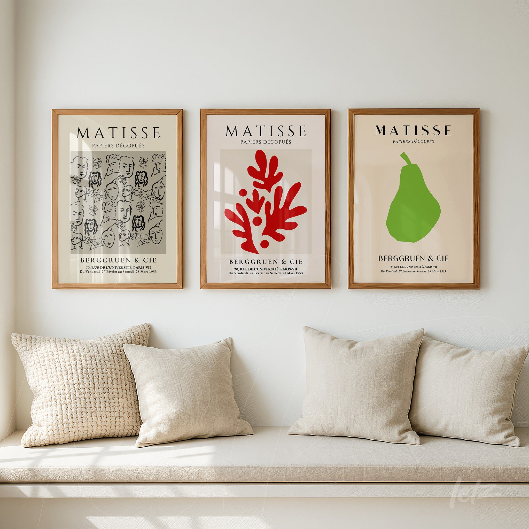 composition of three framed artworks on the wall with light wood frames, showcasing Matisse-inspired designs in red, green, and gray tones