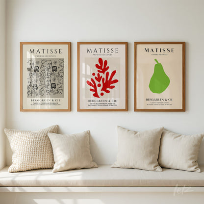 composition of three framed artworks on the wall with light wood frames, showcasing Matisse-inspired designs in red, green, and gray tones