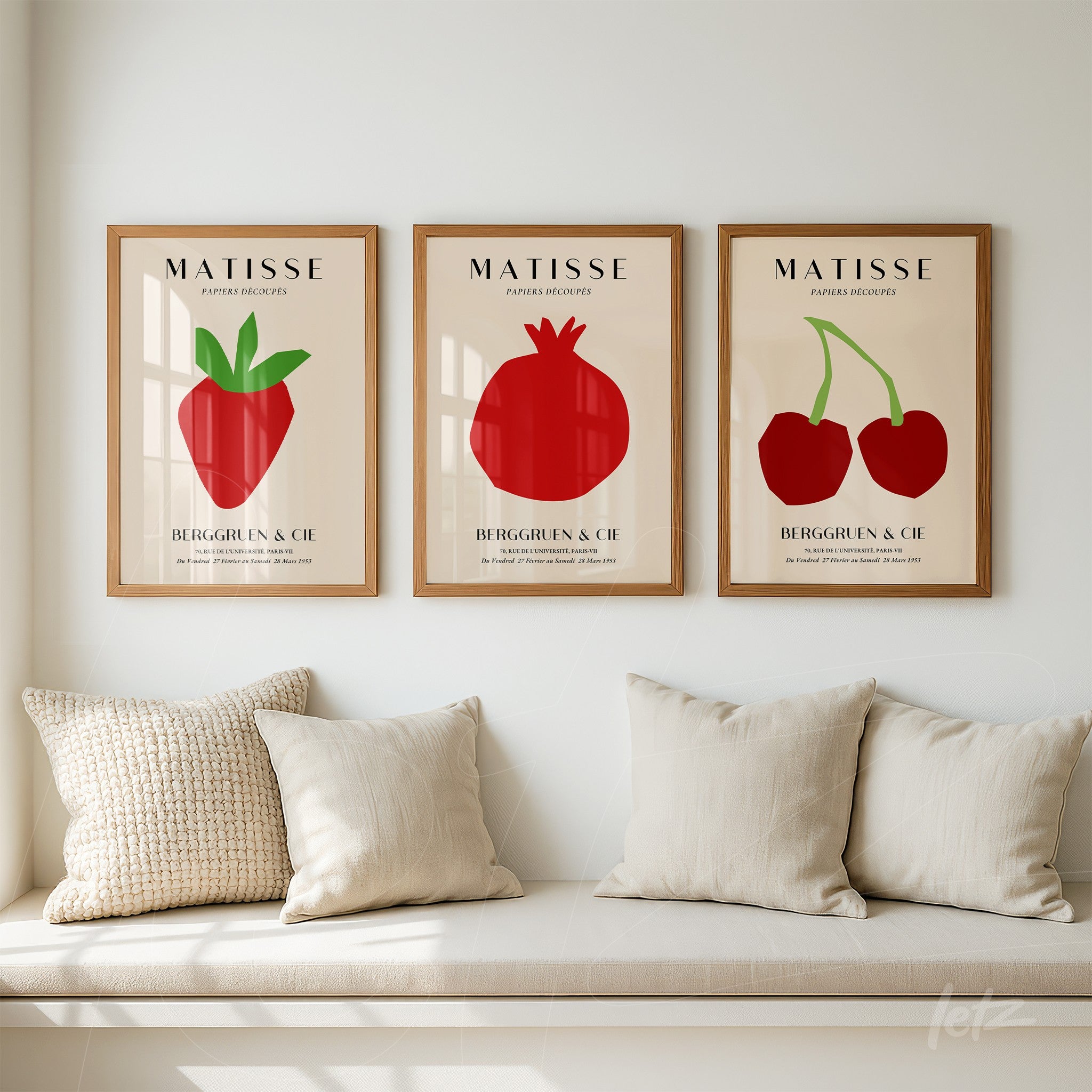 collection of framed minimalist fruit illustrations in light wood frames displayed in a cozy setting with a light cushion sofa