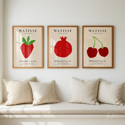 collection of framed minimalist fruit illustrations in light wood frames displayed in a cozy setting with a light cushion sofa