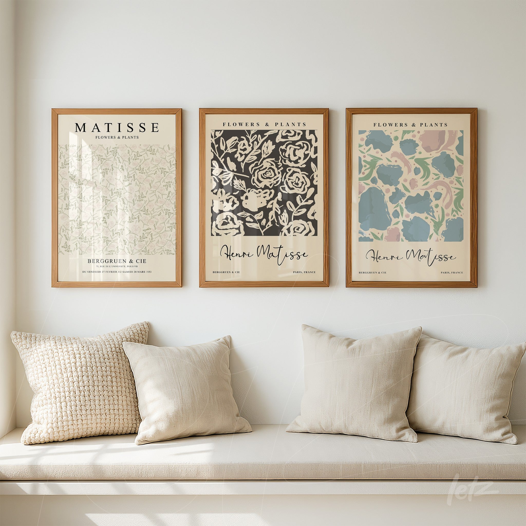 series of decorative wall art featuring flower illustrations in light wooden frames on a white wall