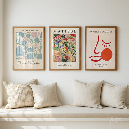 composition of three framed modern art prints in light wood frames featuring colorful illustrations inspired by Henri Matisse on a light wall