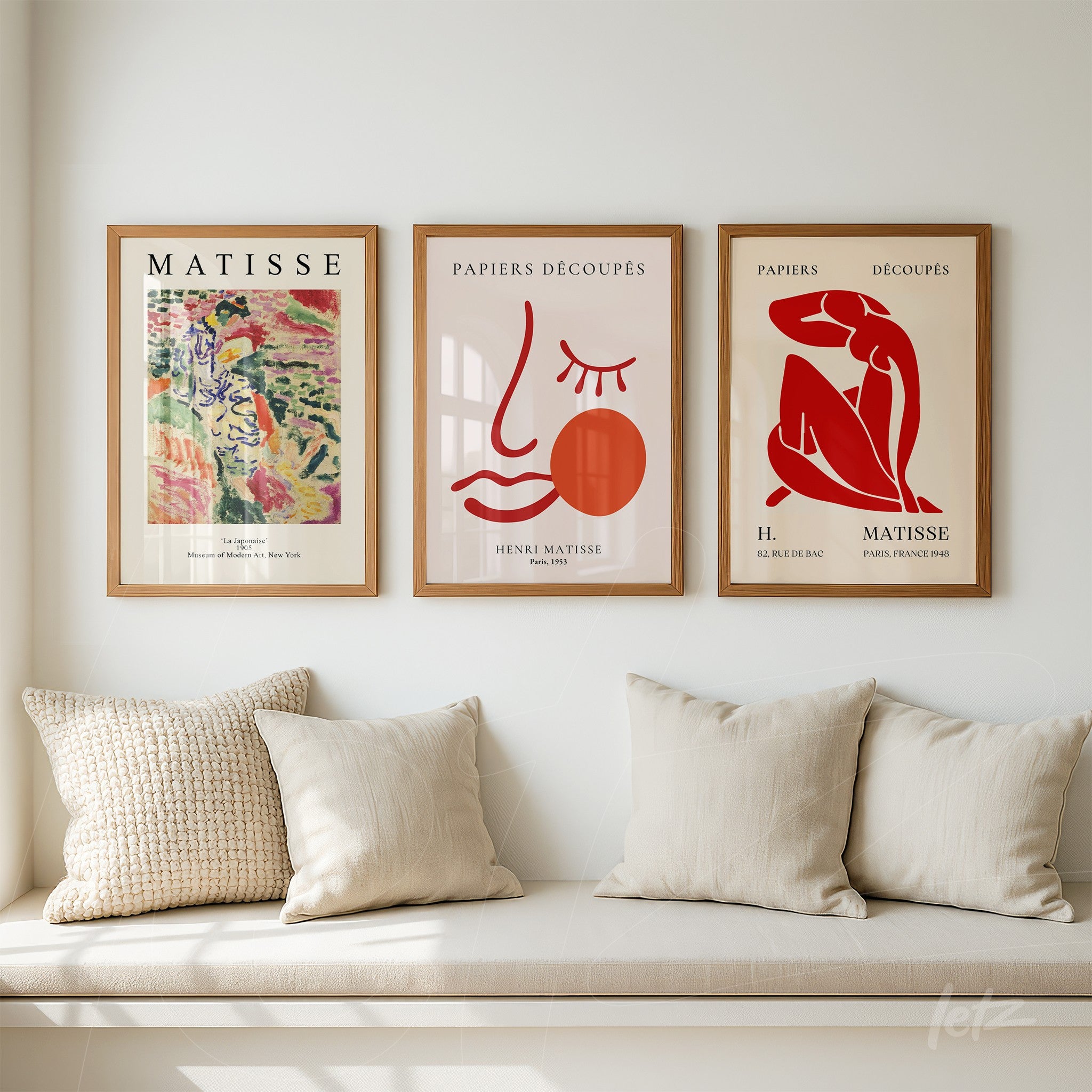 composition featuring three framed artworks inspired by henri matisse in light wood frames displayed above a sofa with neutral cushions