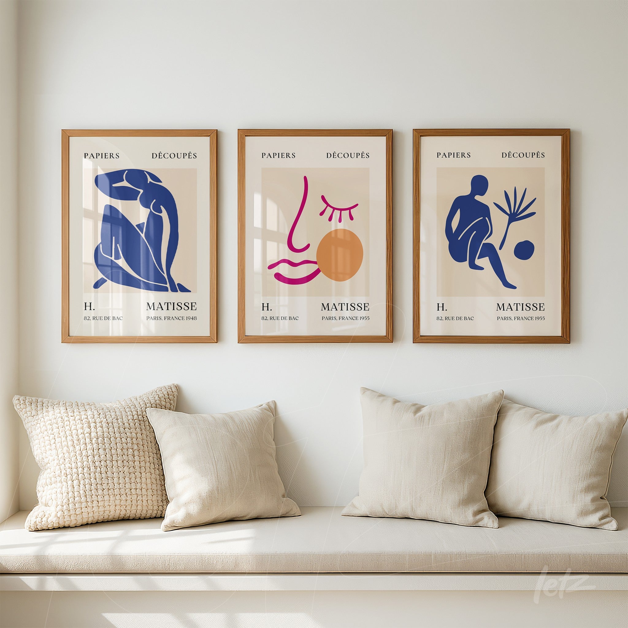 composition of three framed wall art pieces featuring stylized figures and graphic elements in shades of blue and terracotta on cream background