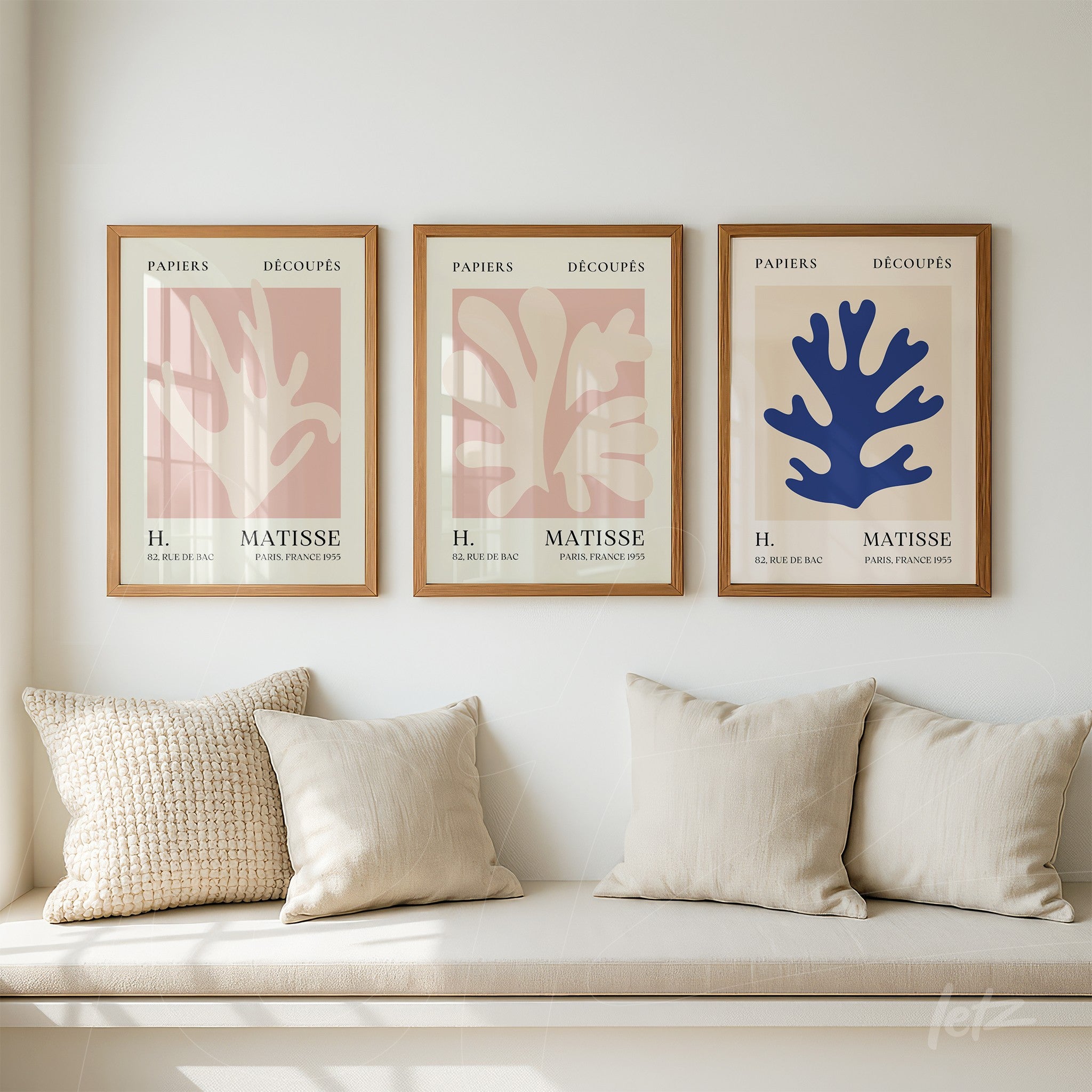 collection of decorative framed art featuring organic shapes in earthy tones and blue, displayed against a white wall