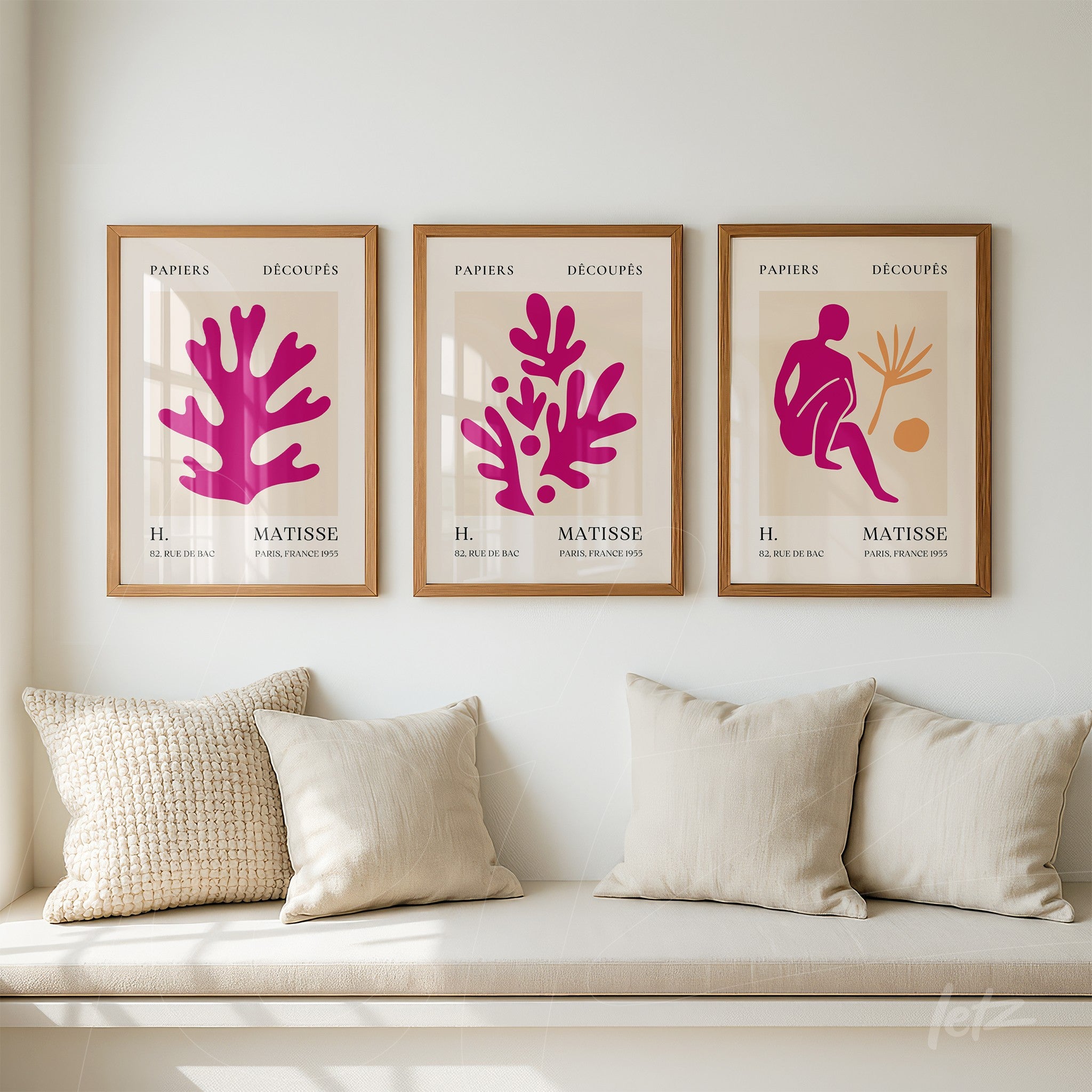 series of framed wall art featuring vibrant cut paper shapes, light wooden frames, displayed on a neutral wall