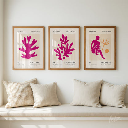 series of framed wall art featuring vibrant cut paper shapes, light wooden frames, displayed on a neutral wall