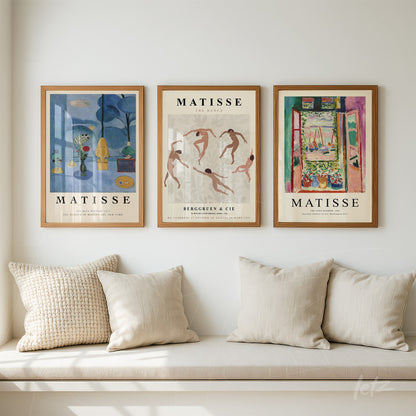 composition of three decorative wall art pieces in light wooden frames featuring reproductions of Matisse's artworks displayed on a white wall