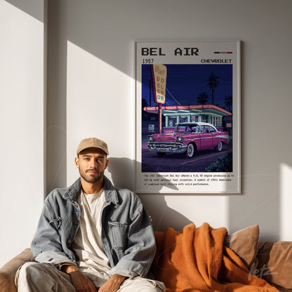framed vintage art of 1957 Chevrolet Bel Air at night, displayed on light wall next to a smiling man with an orange throw blanket