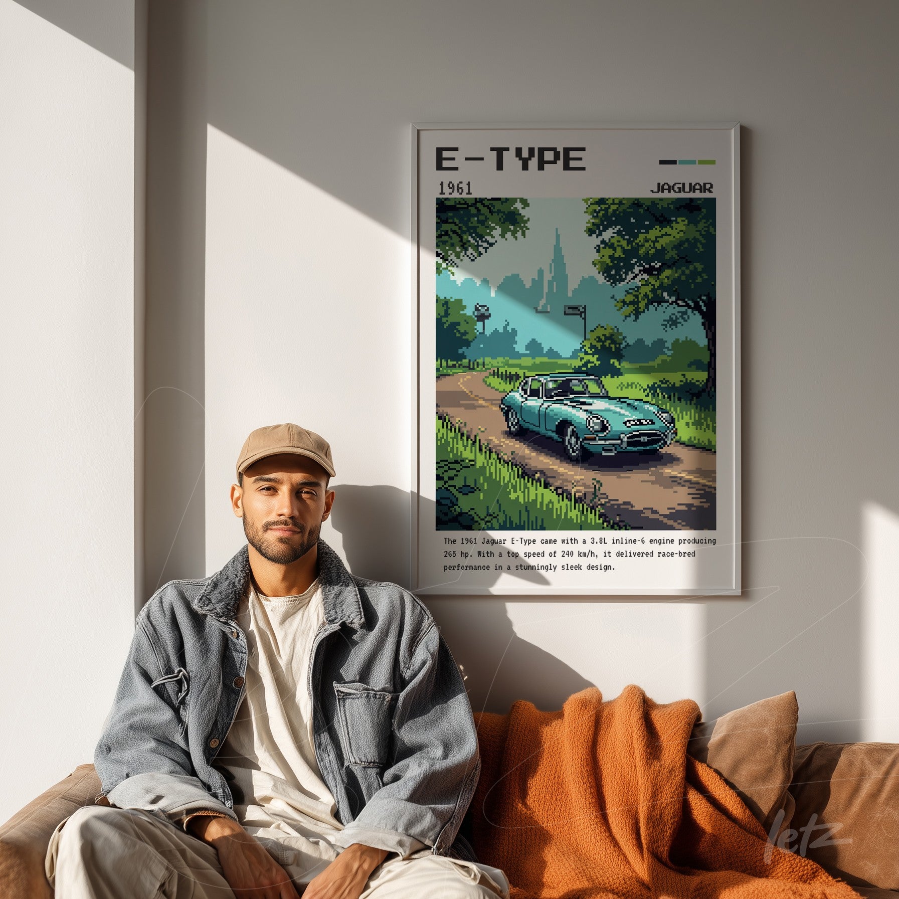 framed retro-style digital art of a 1961 Jaguar E-Type car in a green nature setting displayed in a modern living space with a man sitting beside it