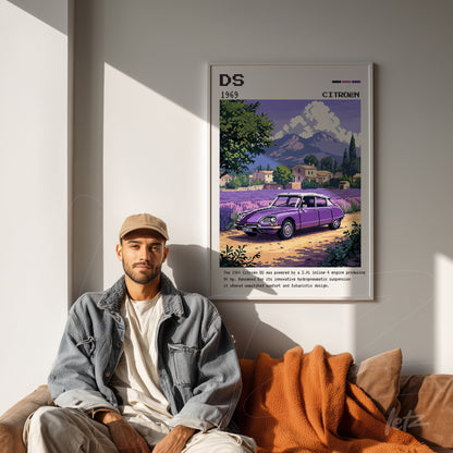framed wall art featuring retro illustration of the 1969 Citroën DS with a white frame, displayed on a light wall with a man sitting on a sofa